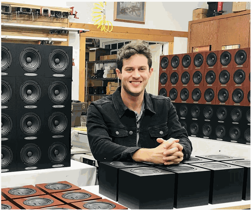 Alex Jacobsen surrounded by Auratone speakers in the workshop